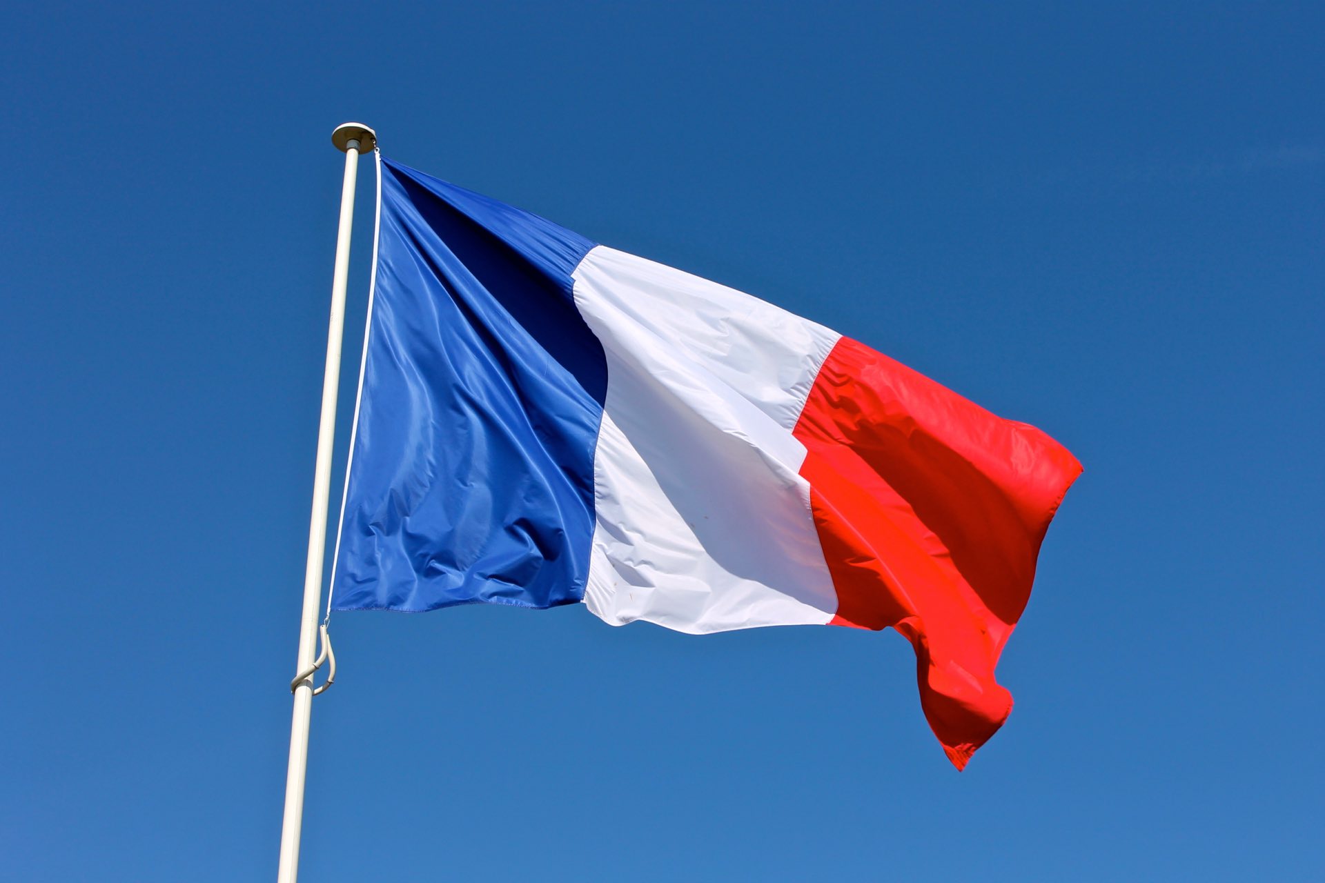 French flag with a blue sky background
