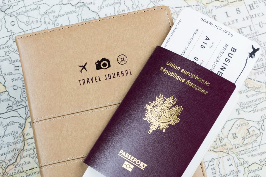 French passport, a travel journal on top of a map
